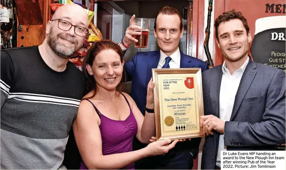  ?? ?? Dr Luke Evans MP handing an award to the New Plough Inn team after winning Pub of the Year 2022. Picture: Jim Tomlinson