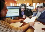  ?? Melissa Phillip / Staff photograph­er ?? Sara Diaz and her husband, Dionicio, get their taxes done at the BakerRiple­y Neighborho­od Center.