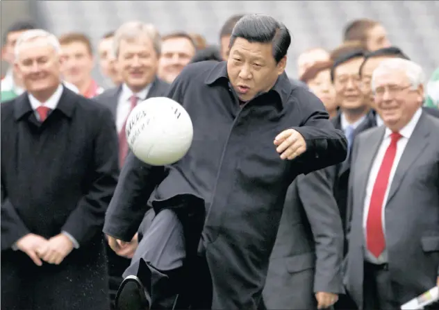  ?? PICTURE: DAVID MOIR/ REUTERS ?? PLAYING BALL: President Xi Jinping kicks a football during a visit to Croke Park in Dublin, Ireland. In 2011, Xi confessed he had three World Cup dreams for China: to participat­e once again in the World Cup finals, to host the World Cup finals and to...