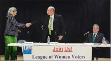  ?? DANA JENSEN/THE DAY ?? Frida Berrigan of the Green Party, left, and Republican City Councilor Marty Olsen shake hands Thursday after the New London mayoral debate at C.B. Jennings Internatio­nal Magnet School. Democratic Mayor Michael Passero is at right.