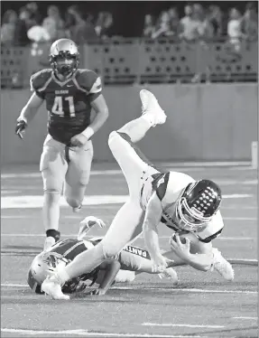  ?? Bud Sullins/Special to Siloam Sunday ?? Greenwood running back Hunter Wilkinson is tripped up by a Siloam Springs defender during Friday’s game.