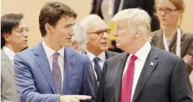  ?? Ansa ?? Così vicini, così lontani Justin Trudeau (45 anni) e Donald Trump (70) all’ultimo G20 di Amburgo, a luglio