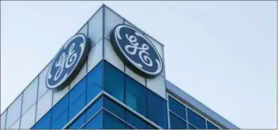  ?? JOHN MINCHILLO — THE ASSOCIATED PRESS FILE ?? The General Electric logo is displayed at the top of their Global Operations Center in the Banks developmen­t of downtown Cincinnati. A year after taking over an ailing American conglomera­te, CEO John Flannery is calving off larger chunks of General...