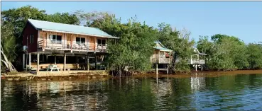  ?? Jim Klug/Yellow Dog Flyfishing Adventures (above) Chris Santella/ Washington Post ?? BELOW: The guest rooms at Garbutt’s Fishing Lodge, perched on stilts above the Caribbean Sea, are full of amenities.