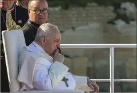  ?? ANDREAS SOLARO — POOL VIA AP ?? Pope Francis sits next to Malta's Archbishop Charles Jude Scicluna, left, aboard a catamaran leaving Valletta's harbor for Gozo in Malta on Saturday.