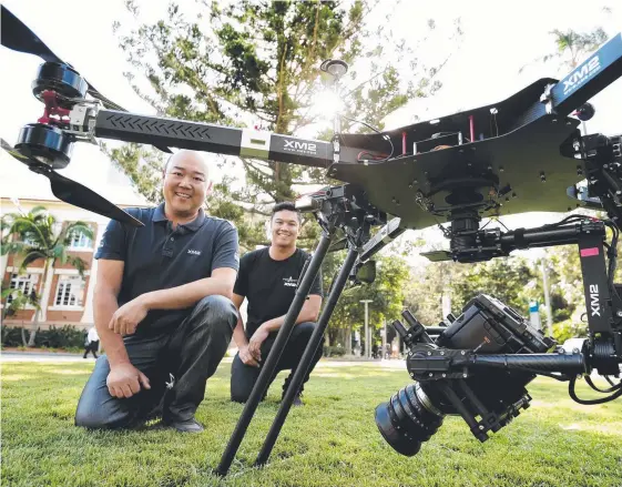  ?? Picture: MARK CALLEJA ?? Stephen Oh and Aidan Kelly from XM2 with one of their drones that will feature at the World of Drones Congress.