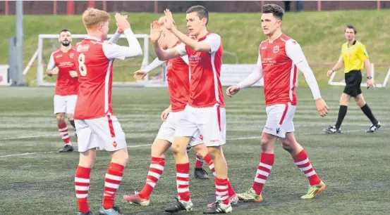  ??  ?? Delight Gordon Donaldson (centre) celebrates with his teammates after nodding home Broxburn’s second goal