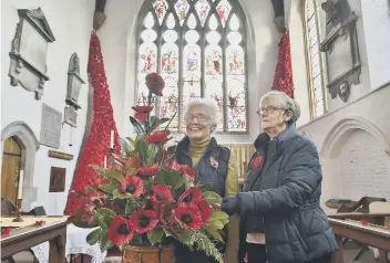  ??  ?? WW1 displays inside St John’s church, Stanground. Jackie Jenkins (church warden) and Jenny Taylor (verger)