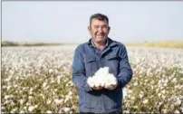  ?? Mu ZHAO GE / XINHUA ?? Erkin Rehim shows cotton from Yuli county on Oct 15. Machines helped the 49-year-old farmer harvest his 550 (36.7 hectares) of fields in 24 hours.