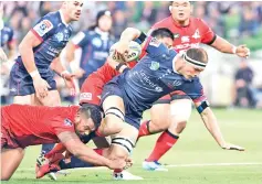  ?? — AFP photo ?? Rebels player Luke Jones (C) is tackled by Sunwolves defender Pauliasi Manu (L) in the Super Rugby match between Australia's Melbourne Rebels and Japan's Sunwolves.