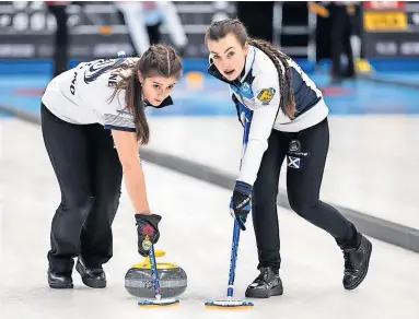  ?? ?? Sweeping to success Holly Wilkie-Milne (left) in action at the World Juniors. Photo: WCF/Cheyenne Boone