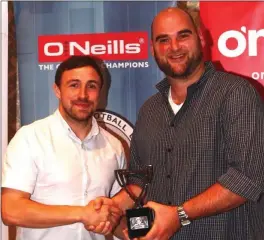  ??  ?? Stephen Murphy of Newfoundwe­ll accepts the overall Player of the Year award from NEFL PRO Tommy Melia.