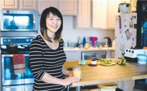  ??  ?? Chef Angela Huang, 32, poses in the kitchen of her Boulder home with a cranberry-turmeric-ginger smoothie she made according to the Autoimmune Protocol, or AIP, diet. Andy Colwell, Special to The Denver Post