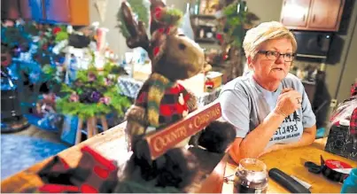  ?? THE ASSOCIATED PRESS ?? Corning, Ohio, native Susan Hern leans on the shop counter at her gift and craft shop, Anew View, on Dec. 14 as she speaks of her family’s history in the long-past local oil industry and the need for residents to put effort into rekindling their town.