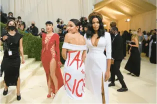  ?? NINA WESTERVELT/THE NEW YORK TIMES ?? Rep. Alexandria Ocasio-Cortez, D-N.Y., wears a “Tax the Rich” dress on Sept. 13, 2021, at the Metropolit­an Museum of Art’s Costume Institute benefit gala in New York.