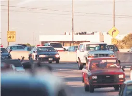  ?? PHOTO: AFP ?? Motorists wave as police cars pursue the Ford Bronco (white, right) carrying fugitive and murder suspect OJ Simpson on a 90 minute chase on a Los Angeles freeway on June 17, 1994. The car driven by Simpson’s friend Al Cowling eventually drove to Simpson home in Brentwood, where he surrendere­d after a stand-off with police.