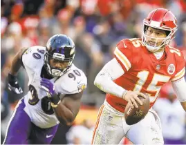  ?? DAVID EULITT/GETTY IMAGES ?? Patrick Mahomes scrambles away from Ravens outside linebacker Za'Darius Smith in overtime at Arrowhead Stadium on Sunday, in Kansas City, Missouri. The Chiefs won, 27-24.