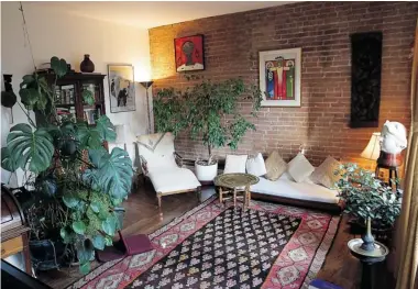  ?? PHOTOS: PIERRE OBENDRAUF/ THE GAZETTE ?? The living room of a condo on St-Cuthbert St. is adorned in plants and pieces collected by Krish, the condo owner.