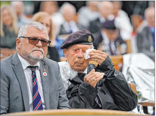  ?? Jacob King The Associated Press ?? A British veteran wipes his eyes while watching the opening of the British Normandy Memorial in France, via a video feed, during a ceremony Sunday — the 77th annivesary of D-day — at the National Memorial Arboretum in Alrewas, in north-central England.