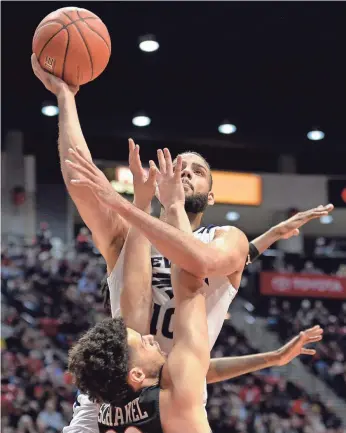  ?? JAKE ROTH/USA TODAY ?? Caleb Martin (10), guarded by San Diego State’s Jordan Schakel, leads Nevada in scoring (19.6 points) and is one of the favorites to win the MWC’s player of the year award.