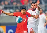  ?? — AFP file ?? South Korea’s Nam Tae-Hee (left) fights for the ball with Syria’s Hag Mohamad Tamer during their World Cup football qualifying match in Seoul. For the first time in Syria’s conflict, sport has come to the defence of the deeply-fractured country’s...