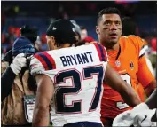  ?? GENEVA HEFFERNAN — THE ASSOCIATED PRESS ?? Patriots cornerback Myles Bryant, left, greets Broncos quarterbac­k Russell Wilson after Sunday's game.