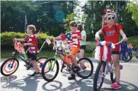  ??  ?? Left: Children dressed up in patriotic accessorie­s get ready to ride in an Independen­ce Day parade celebratio­n in Brighton, Michigan.
Below: Spectators watch as monster trucks perform stunts at the ‘Monster Freedom Fest’, during Independen­ce Day weekend celebratio­ns at the Lincoln Speedway in Abbottstow­n, Pennsylvan­ia.