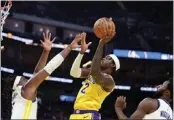  ?? EZRA SHAW — GETTY IMAGES ?? The Lakers' Jarred Vanderbilt goes up for a shot over the Warriors' Kevon Looney at Chase Center on Saturday.