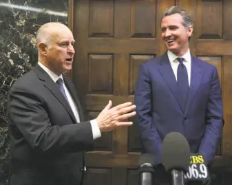  ?? Rich Pedroncell­i / Associated Press ?? Gov.-elect Gavin Newsom (right) will take the reins from Gov. Jerry Brown (left), who backed legislatio­n allowing utilities in some cases to borrow money for wildfire damages and tap their customers to repay the loans.