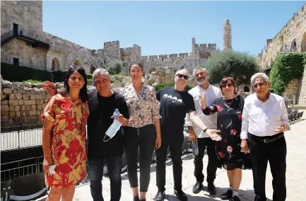  ?? (Ricky Rachman) ?? TOWER OF DAVID MUSEUM director Eilat Lieber (from left), Gavri Banai, exhibition curator Tal Kobo, music historian Yoav Kutner, and Eviatar Banai and his parents, Simcha and retired judge Yitzhak Banai, pose for a photo at the Tower of David Museum.