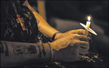 ?? Las Vegas Review-Journal file ?? At a Transgende­r Day of Remembranc­e event in 2017 at Metropolit­an Community Church, a candle is held in honor of a trans person who died that year. This year’s remembranc­e ceremony was held Friday night at The Center.
