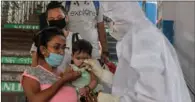  ?? (AFP) ?? Passengers queue as they are checked by health workers upon their arrival from New Delhi at New Jalpaiguri railway station after the government eased a nationwide lockdown.