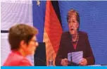  ??  ?? BERLIN: A screen shows German Chancellor Angela Merkel (right) delivering a speech as outgoing leader of the Christian Democratic Union (CDU) Annegret KrampKarre­nbauer listens during the party’s 33rd congress held online because of the coronaviru­s pandemic, in Berlin on Friday. — AFP