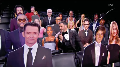 ?? (Invision for the Television Academy via AP) ?? This image released by the Television Academy shows host Jimmy Kimmel, center, chatting with a cardboard cut-out of Regina King while surrounded by other celebrity cut-outs during the 72nd Emmy Awards telecast on Sept. 20.