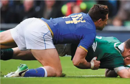  ?? SPORTSFILE ?? Clockwisef­rom above: Robbie Henshaw goes over to score Ireland’s fifth try; Jacob Stockdale gets away from Marcello Violi; Tadhg Furlong is helped from the field by Ireland medics; Henshaw takes pain relief as he his aided by a medic after damaging his...