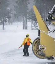  ?? Brian van der Brug Los Angeles Times ?? A WORKER at Mammoth Mountain ski area is dwarfed by snow removal equipment this week.