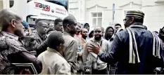  ?? AFP ?? Moscow: Ambassador of Nigeria to Russia Steve Davies Ugbah (R,back) speaks with Nigerians in front of Nigerian embassy in Moscow on July 13, 2918. Fraudsters have tricked scores of Nigerians by selling them football World Cup fan passes to travel to...