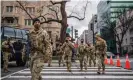  ?? Photograph: Brandon Bell/Getty Images ?? National guard troops walk the streets in Washington DC on 17 January.