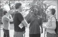  ?? NWA Democrat-Gazette/CHARLIE KAIJO ?? Anthony Bland, a candidate for Secretary of State, meets with constituen­ts Gary and Nancy Kahanak of Fayettevil­le Saturday during a fundraisin­g picnic at the city park.