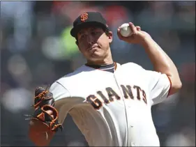  ??  ?? San Francisco Giants pitcher Derek Holland works against the San Diego Padres in the first inning of a baseball game on Wednesday, in San Francisco. AP PHOTO/BEN MARGOT