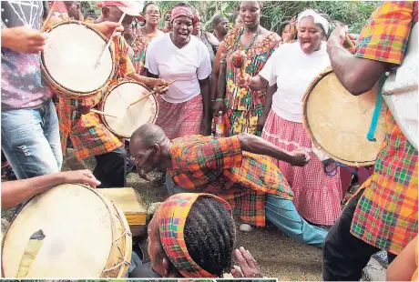  ??  ?? A Maroon dancer (centre) in his usual element, dancing with the ancestors.