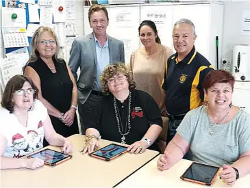  ??  ?? Inspecting the computer tablets with Mawarra clients are (from left) Janine Millar, Lyn Bennett-Colls, Mike Lane, Margaret Willems Van Dyk, Cindy Smith, Vaughan Fox, and Julie Trease.