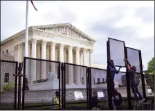  ?? DREW ANGERER/GETTY IMAGES/TNS ?? Workers add additional height to the security fencing surroundin­g the U.S. Supreme Court on May 11, 2022, in Washington, D.C. On Wednesday, the Senate failed to advance the Women's Health Protection Act, a Democrat-led bill that would effectivel­y codify a right to an abortion nationwide.