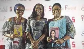  ??  ?? This file photo taken in Abeokuta, southwest Nigeria shows Moderator Molara Wood (center) flanked by authors Ayisha Osori (left) and Bisi Adeleye-Fayemi, posing with their books after a discourse on “Disrupting culture: women in politics” during the...