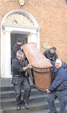  ?? PHOTO: COLIN O RIORDAN ?? Orders: Workers for the Dublin City Sheriff remove items from Gerald Kean’s offices in Dublin yesterday.
