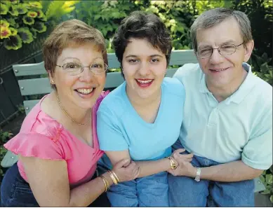  ?? — POSTMEDIA NEWS FILES ?? Suzanne McFarlane, Jennica and Roland Ferdynus, left to right, enjoy a summer day in their back yard garden in 2006. Suzanne and Roland adopted Jennica from Romania.
