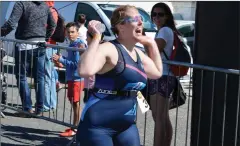  ?? Photo by Fergus Dennehy. ?? This runner cannot help but laugh as she crosses the finish line of the Tri Kingdom Come on Saturday.