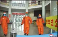  ?? (AP/Korean Central News Agency/Korea News Service) ?? In this photo provided by the North Korean government, station staff disinfect the floor of Pyongyang station Tuesday to curb the spread of covid-19 in Pyongyang. Independen­t journalist­s were not given access to cover the event depicted in this image. The content of this image is as provided and cannot be independen­tly verified.