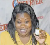  ??  ?? Tameika displays a bottle of her Vitamin C Super Charge Serum, which she says is her most popular product. According to the Hiz Essence founder and operator, the product is “like a facelift in a bottle”.