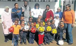  ??  ?? Maritzburg United midfielder Fortune Makaringe [in grey top] with the staff members and the kids at My Hope Day Care Centre & Pre-School at Vosloorus.